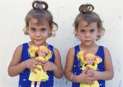 children twins with dolls