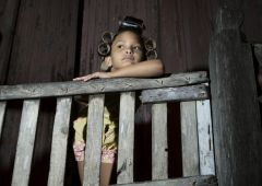 girl leaning against wood railing